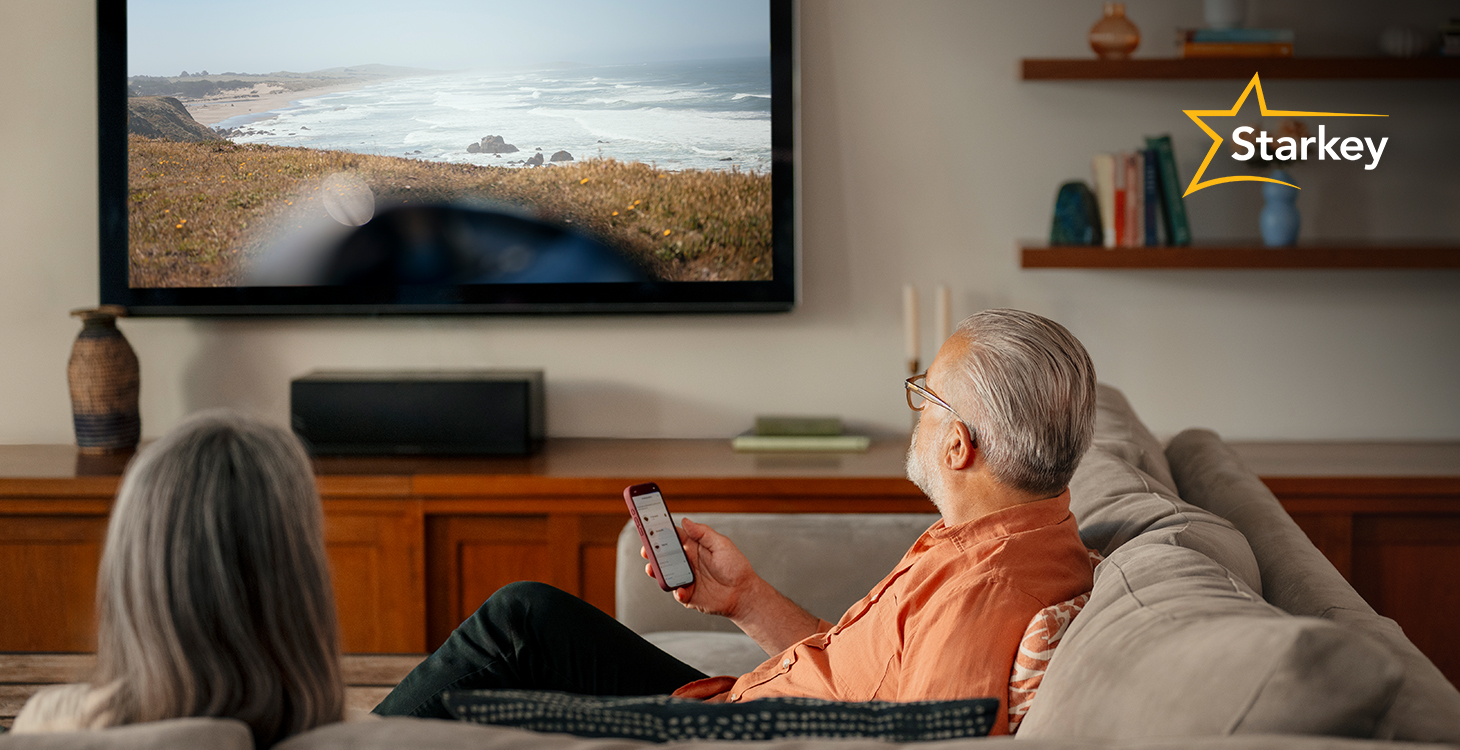 Image of man selecting his smart TV on his My Starkey app so he can stream to his hearing aids